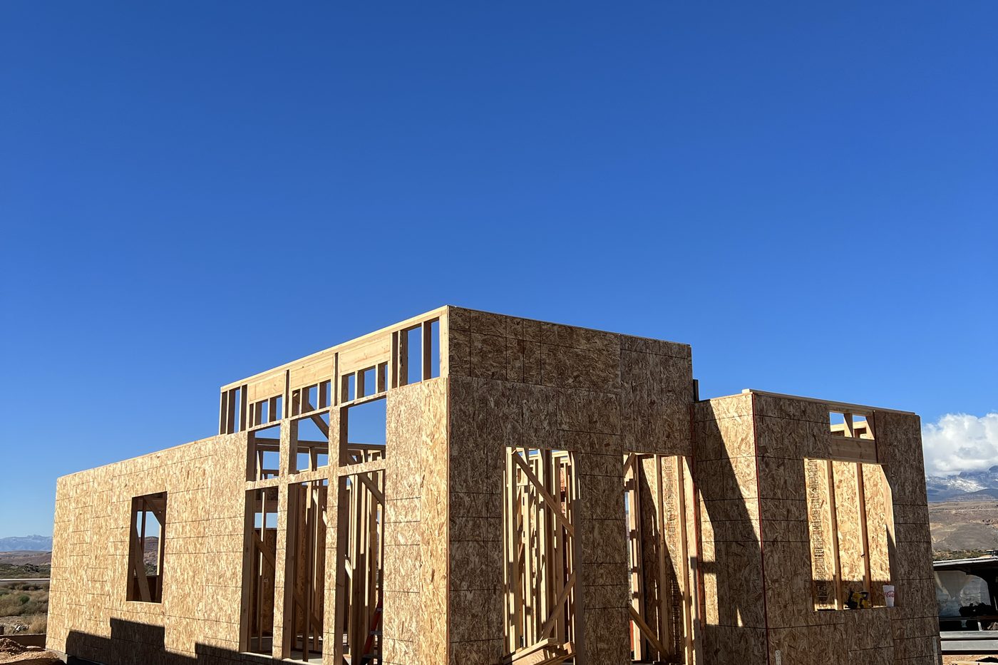 Framed and sheathed walls of a new home with window openings